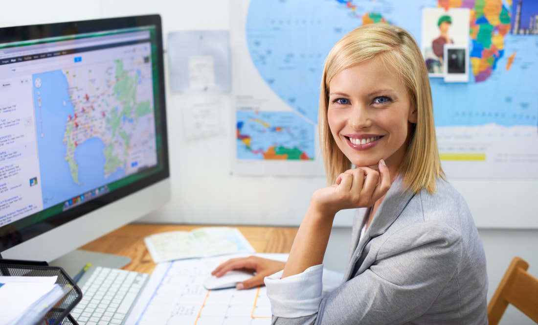 Woman sitting at desk surrounded by maps